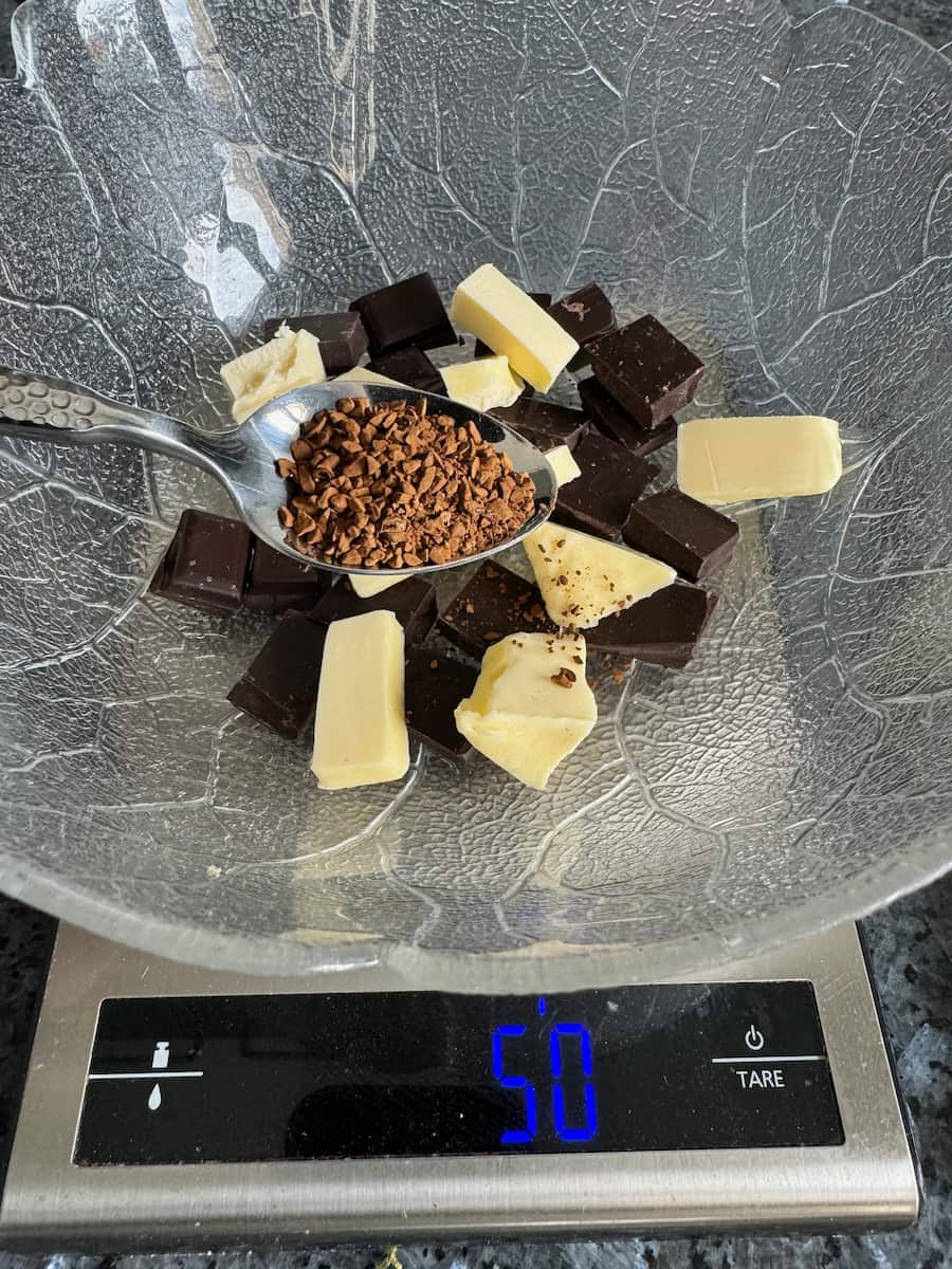 Chocolate coffee fondant cakes broken chocolate, butter chunks and coffee granules in a bowl