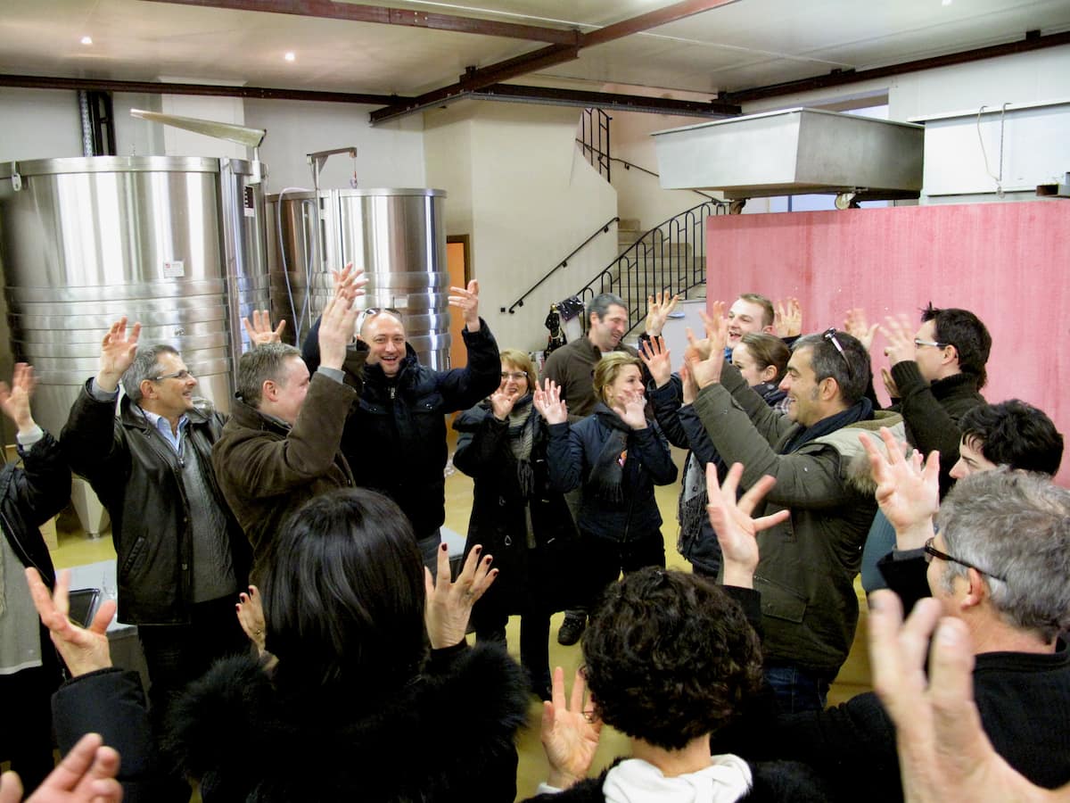 Burgundy white wine tasting Domaine Ramonet hand waving and singing among the wine growers of Burgundy
