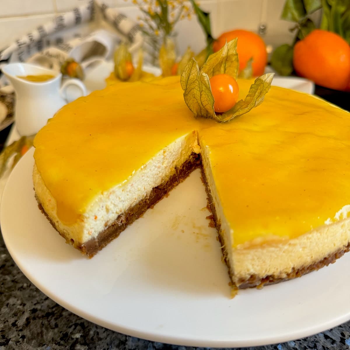 Orange-cheesecake-fruit-decoration-close-up baked orange cheesecake topped with mango coulis