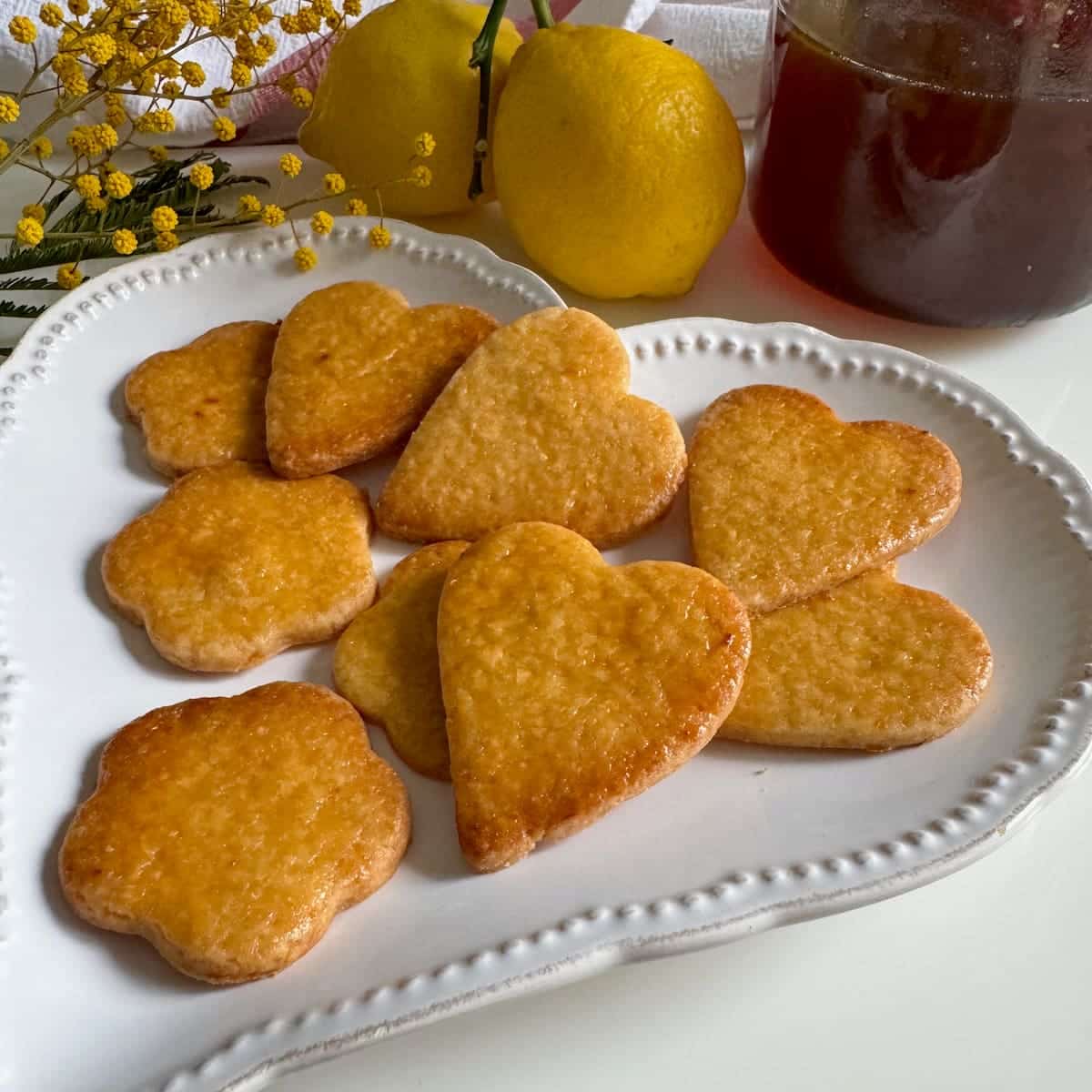 honey and lemon sablé biscuits honey biscuits or cookies, golden, glazed and in love heart shapes