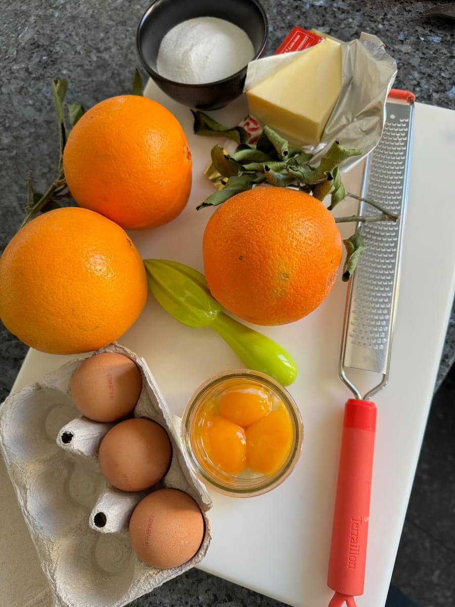 oranges with leaves, fresh eggs, yolks, butter and sugar - curd ingredients