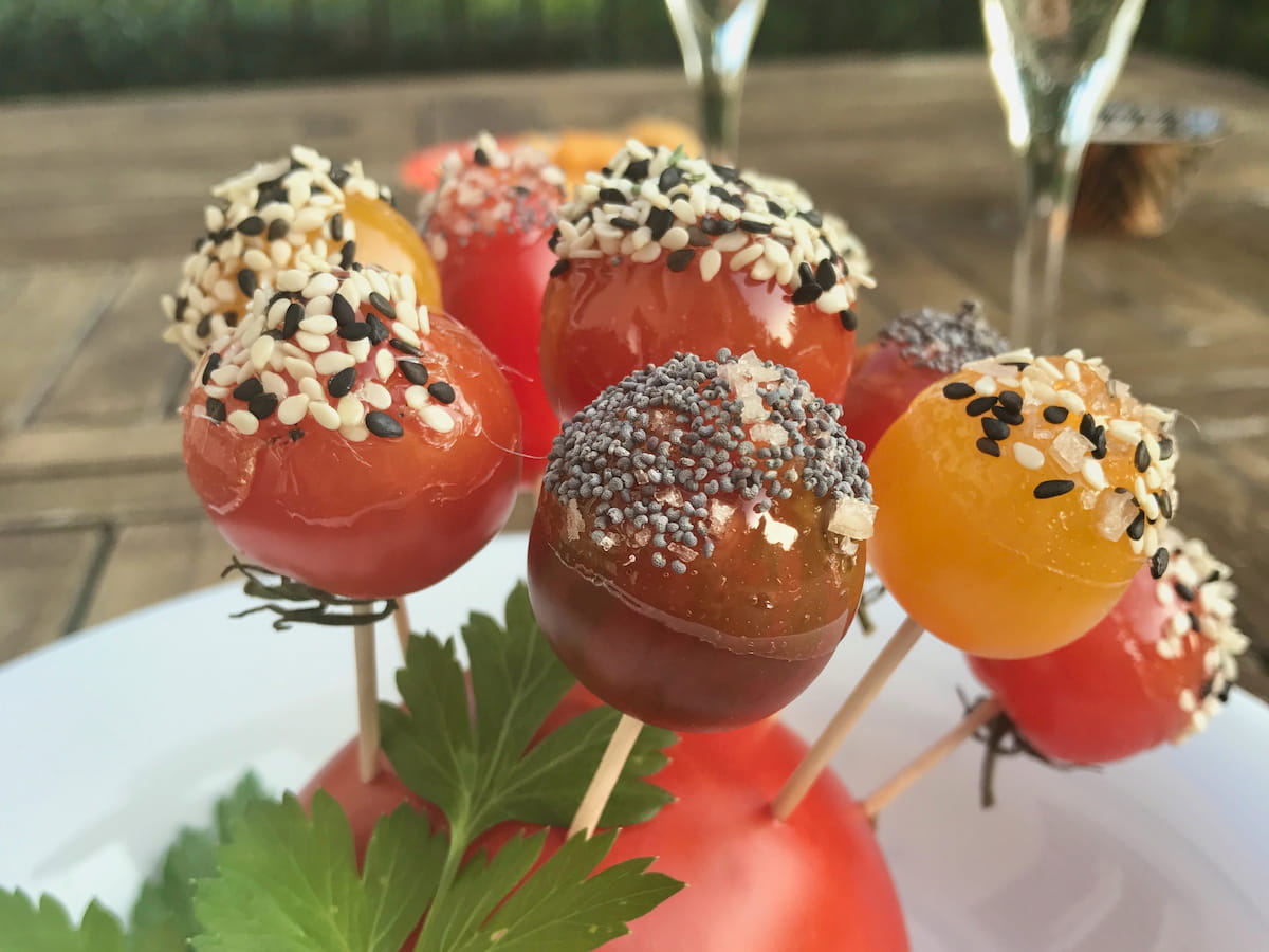 cherry tomatoes coated in salted toffee and mixed sesame and poppy seeds