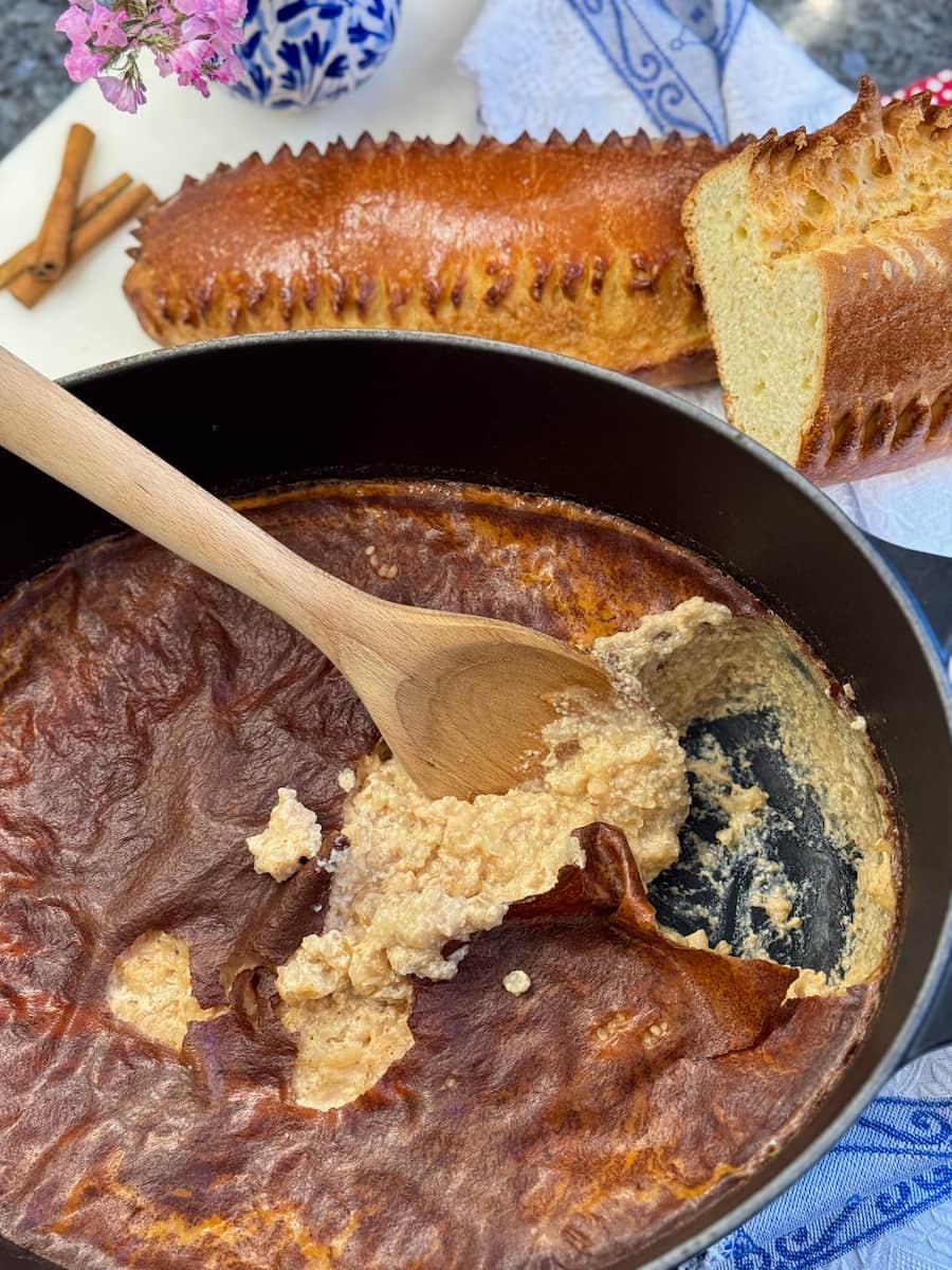 creamy rice pudding out of the oven with a dark skin on it, served with the traditional French Fallue brioche