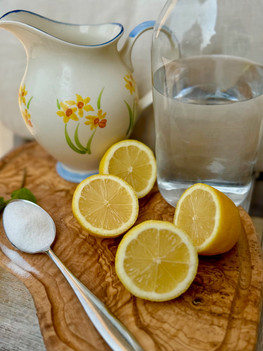 2 lemons cut in half with a tablespoon of sugar and carafe of water